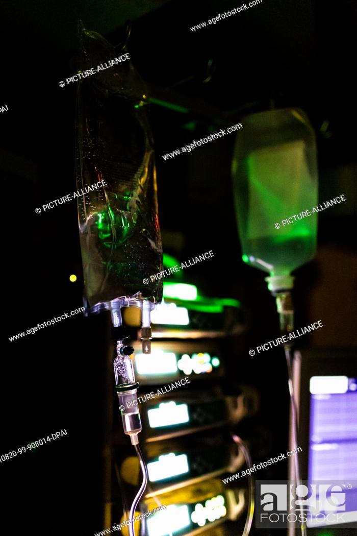 Stock Photo: 23 July 2021, Baden-Wuerttemberg, Freiburg: Two infusion bags are hanging in a hospital room of the anaesthesiological intensive care unit at the University.