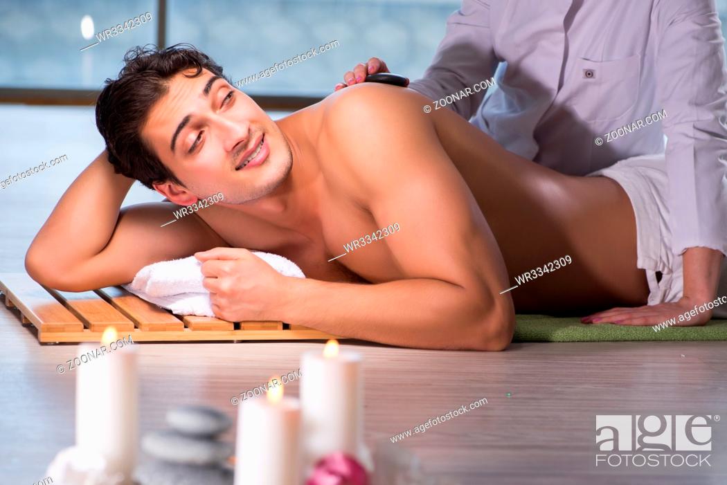 Stock Photo: Young handsome man during spa procedure.