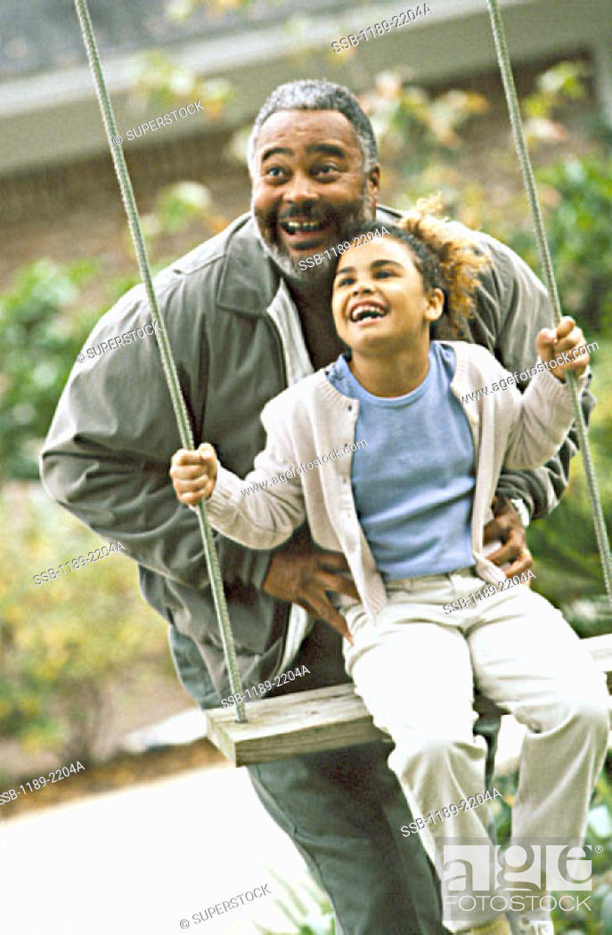 Stock Photo: African-American, Outdoors, People, Vertical, Happy, Smile, Laughing, Playful, Family, Playing, Carefree, Pushing, Grandchild, Granddaughter, Grandfather, Grandparent, Swinging, Grandkid, Swing