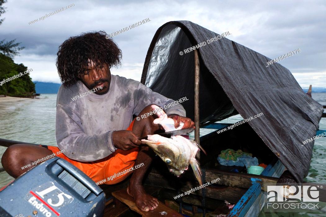 Stock Photo: Fisherman on Outrigger Boat, Cenderawasih Bay, West Papua, Indonesia.