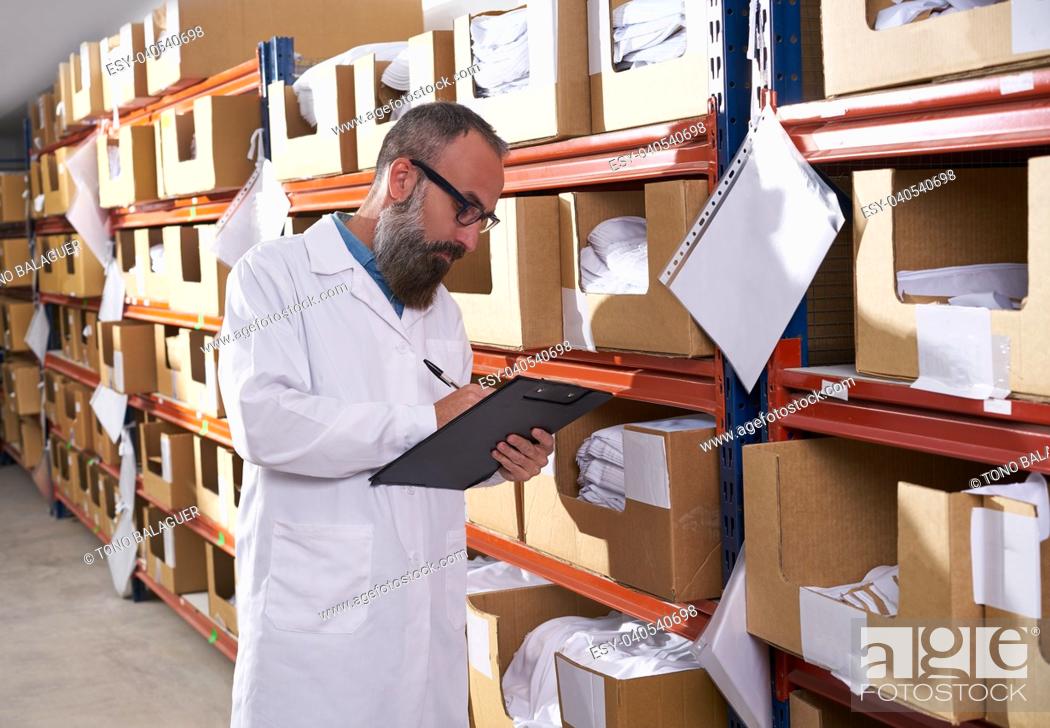 Stock Photo: warehouse supervisor manager man in fashion textile factory with hipster beard.