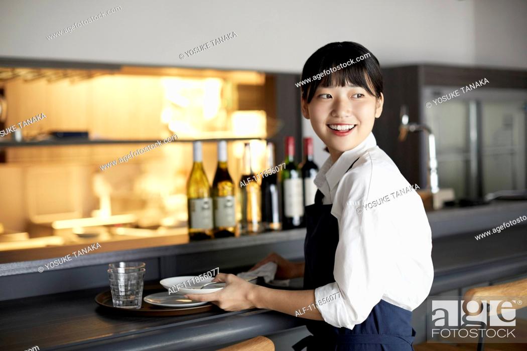 Stock Photo: Young Japanese woman working at a restaurant.