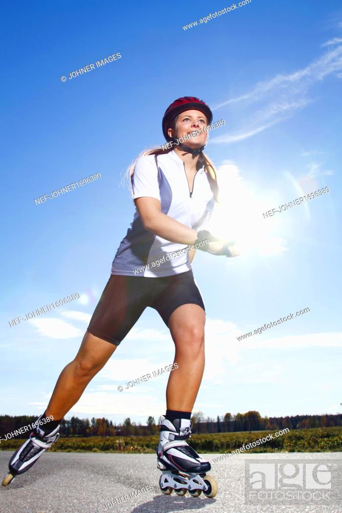 Photo de stock: Smiling woman on rollerblades.