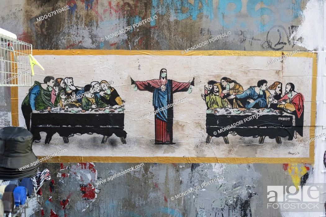 Stock Photo: An ironic poster of the Last Supper with Jesus dividing the table in half due to the high presence of the apostles, given that the latest DPCM limits the number.