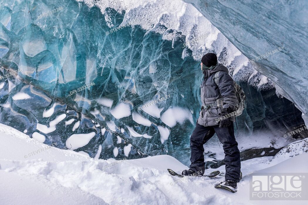 Stock Photo: Fort Greely soldier observing the ice inside a cave on Canwell Glacier in the Delta Mountains of the Alaska Range; Alaska, United States of America.