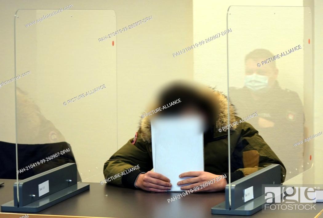 Stock Photo: 19 April 2021, Hamburg: A defendant sits in the courtroom of the St. Georg District Court at the beginning of the trial against him and an accomplice for joint.