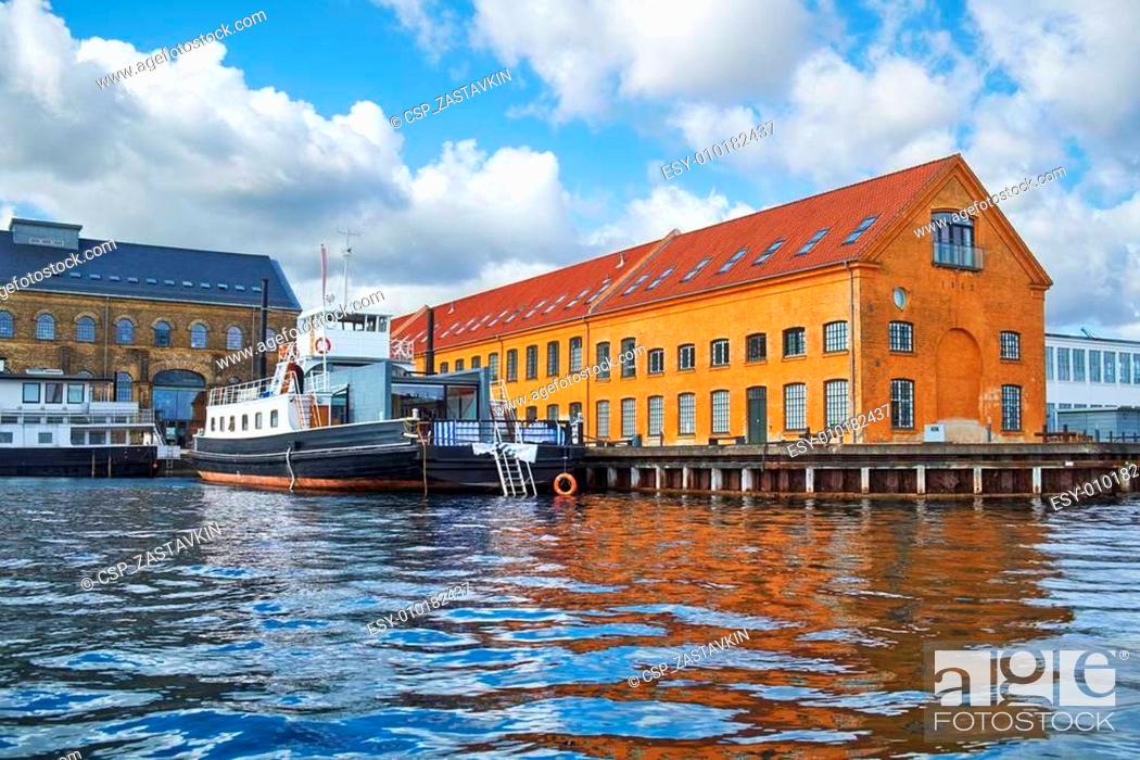 Stock Photo: The moored ship near quaysidenear with red roof house in Copenha.