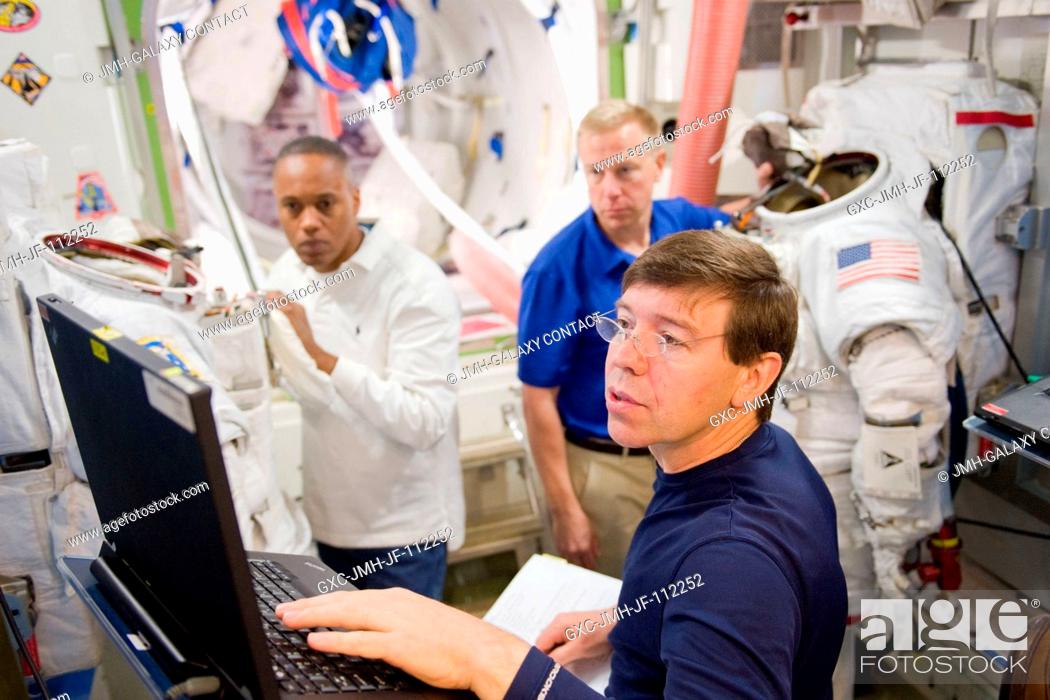 Stock Photo: NASA astronauts Michael Barratt (foreground), Alvin Drew (left background) and Tim Kopra, all STS-133 mission specialists.
