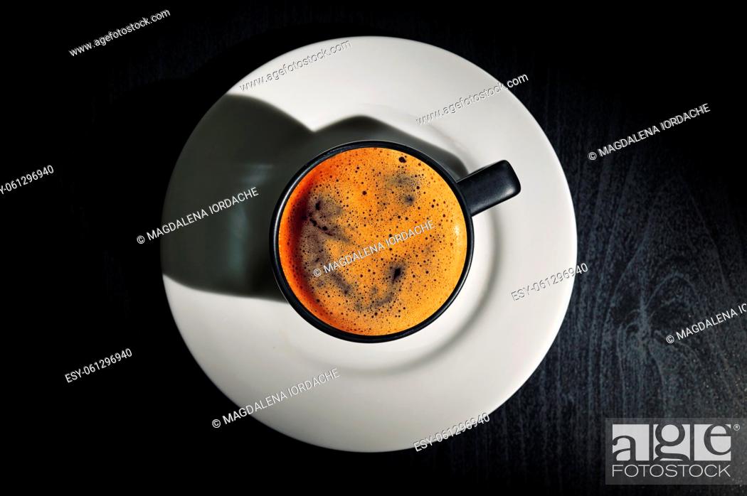 Stock Photo: Black espresso cup and Shadow on black table.