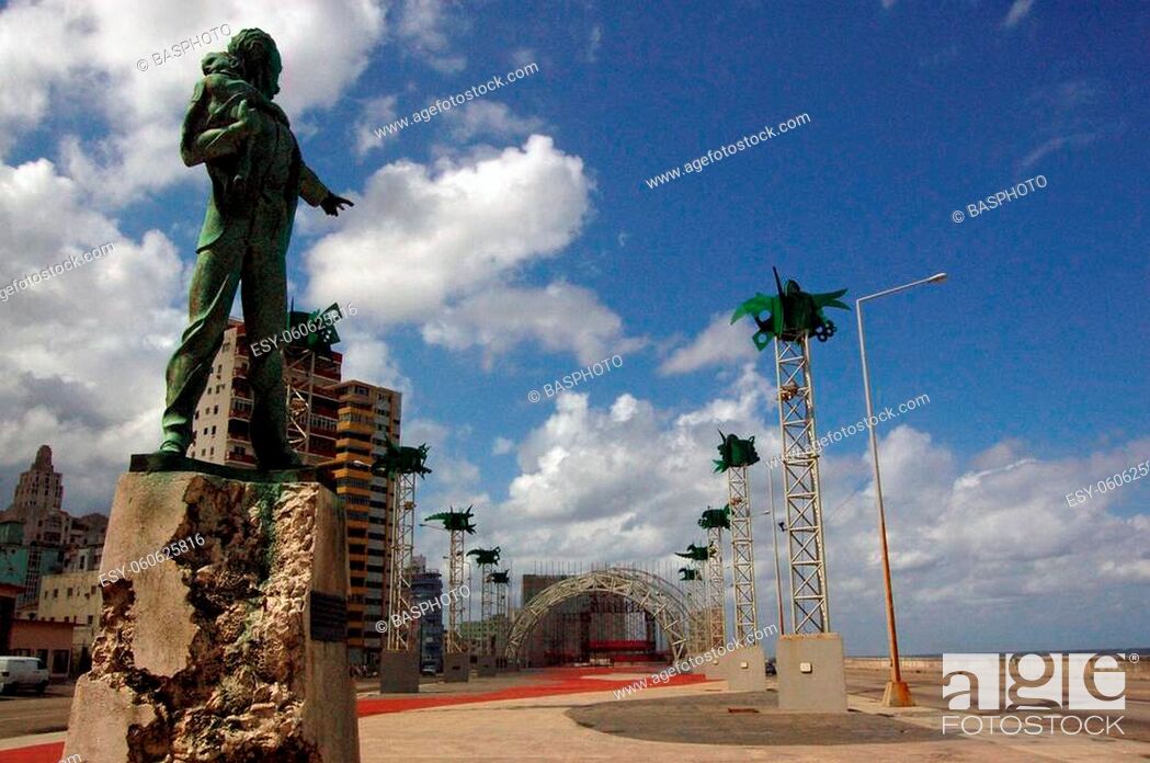 Stock Photo: Anti-Imperialist square in Havana. statue of Jose Marti, holding a baby, to the right is the Malecon and the sea and in the distance is the American Interests.