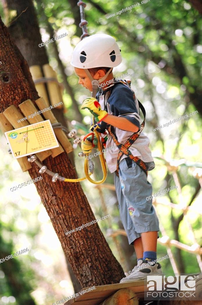 Stock Photo: Child climbing trees.