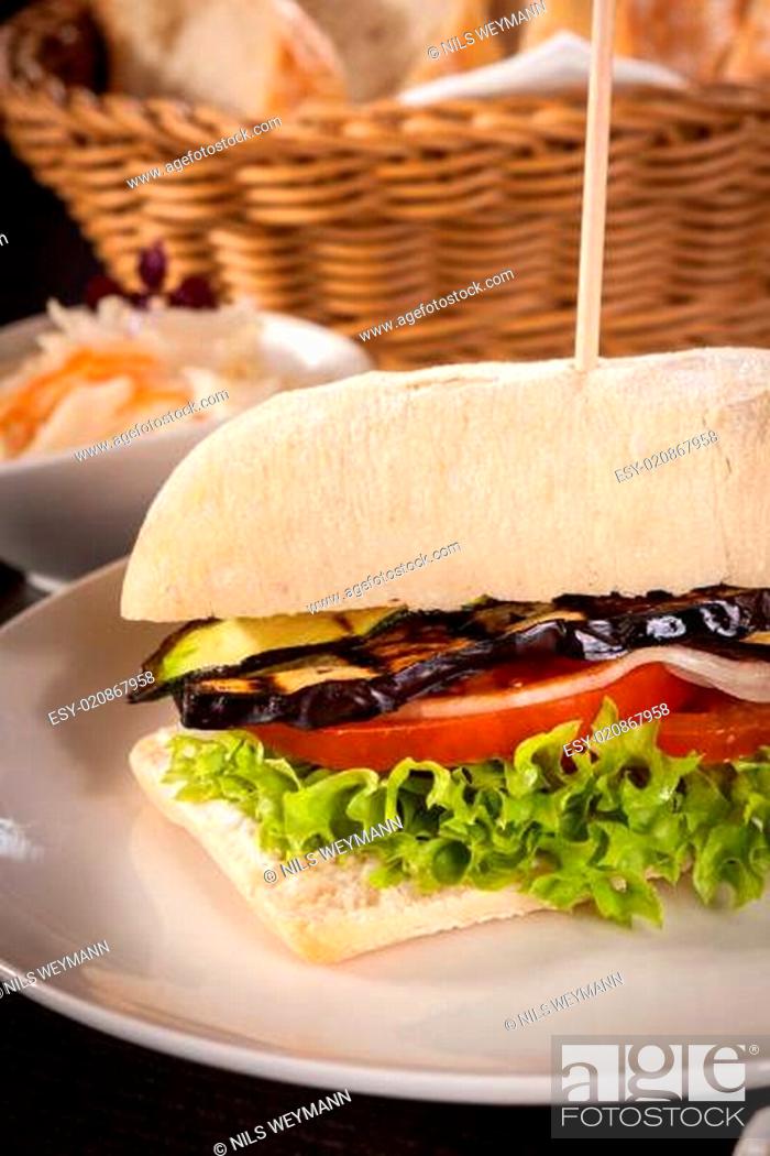 Stock Photo: vegetarian vegetarian hamburger with eggplant tomato and lettuce in a ciabatta roll.