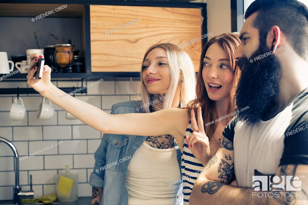 Stock Photo: Friends posing together for selfie with smartphone.