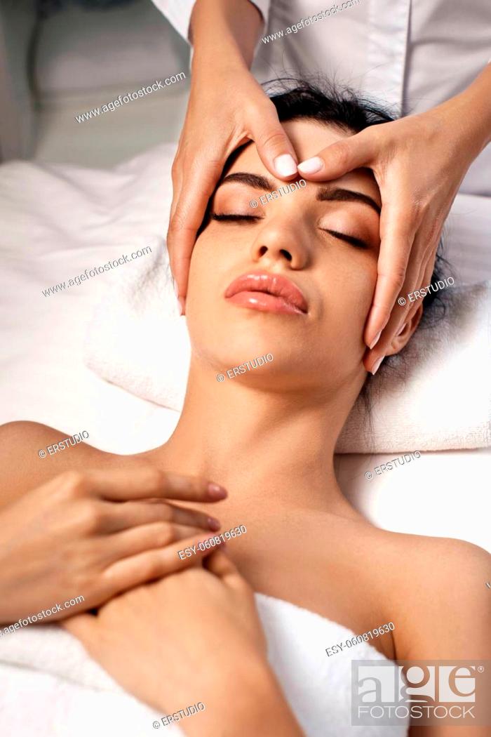 Stock Photo: anti-aging facial massage. Woman receiving massage from masseur at Spa salon.