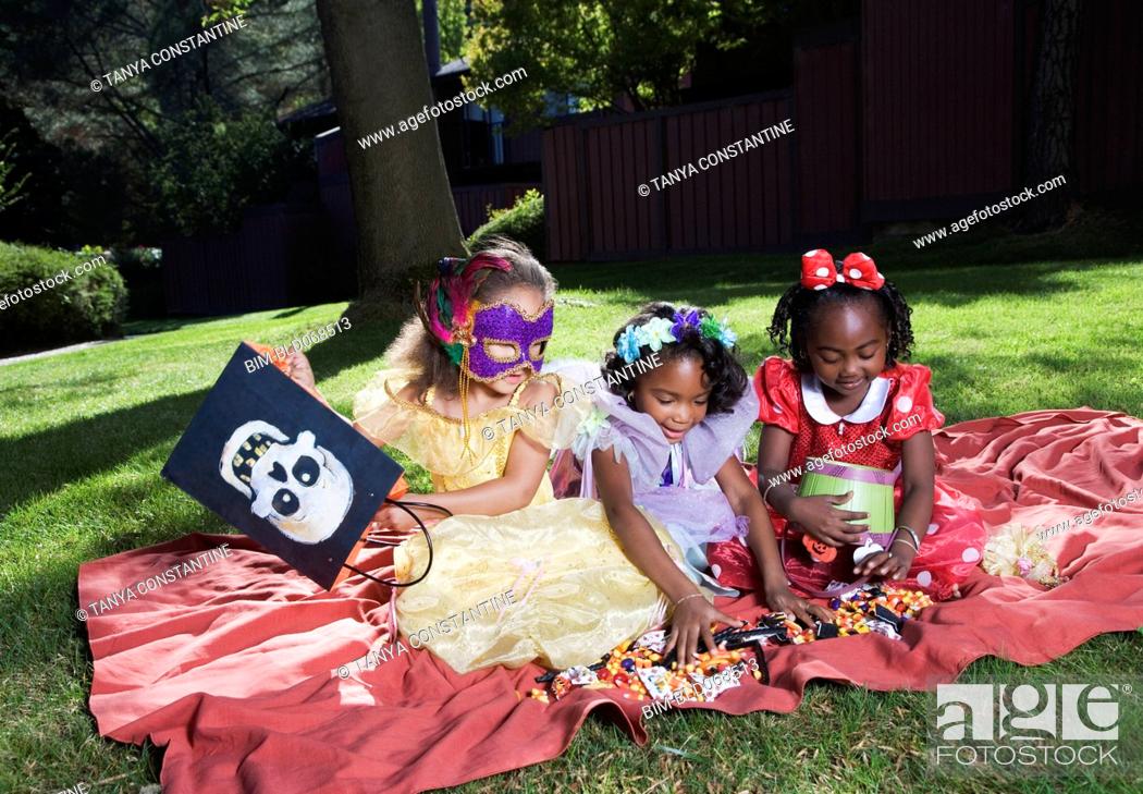 Stock Photo: African girls counting Halloween candy.