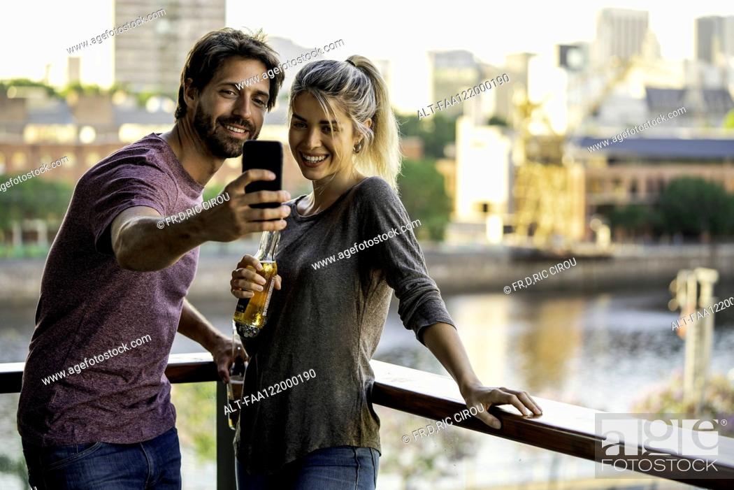 Stock Photo: Young couple taking selfie.
