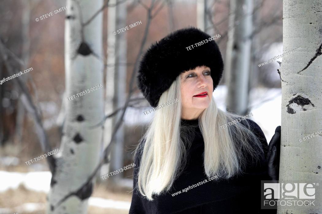 Stock Photo: Woman with ushanka in forest.