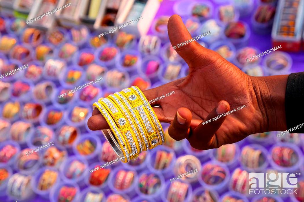 Stock Photo: Man showing bracelets at the market, Jaipur, India.