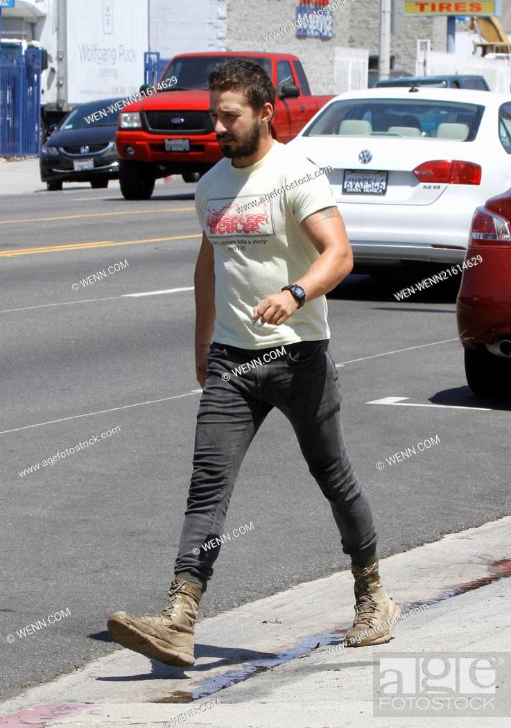 Stock Photo: Shia LaBeouf returning to his vehicle caught wearing a t-shirt that says, 'Every picture tells a story - don't it!' Featuring: Shia LaBeouf Where: Los Angeles.