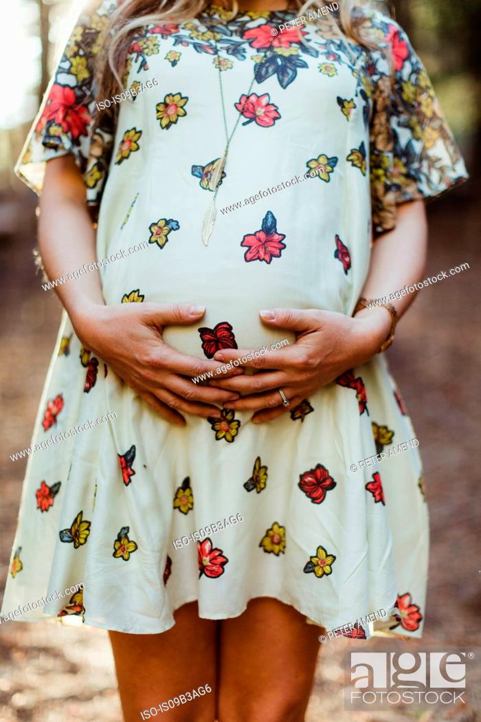 Stock Photo: Pregnant woman touching stomach.