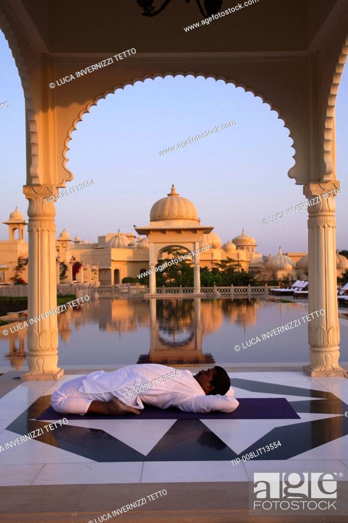 Stock Photo: India, Udaipur, Rajastan, Uberoi Udai Vilas Hotel, man doing yoga.