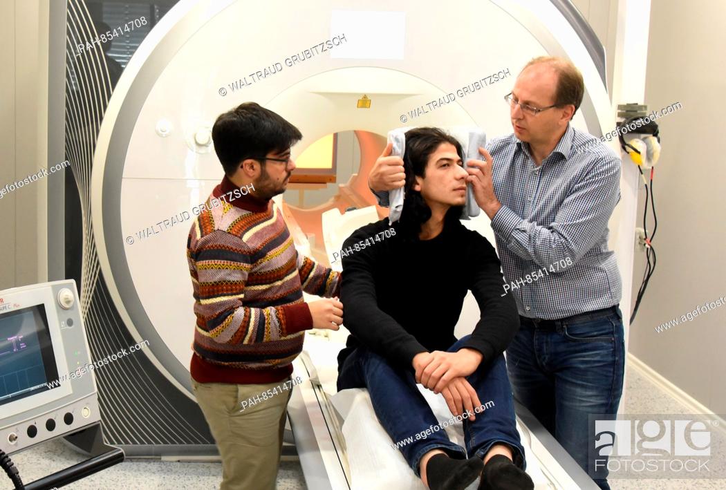 Stock Photo: Scientists and study conductor Dr. Alfred Anwander (r) and Portuguese Tomas Goucha of the Max-Planck-Institute for Cognitive and Neuroscience prepare the.