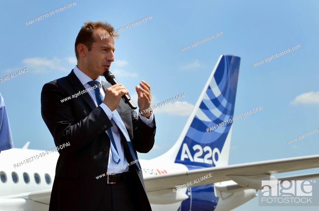 Stock Photo: 10 July 2018, France, Toulouse: Airbus commercial aircraft CEO Guillaume Faury delivers a speech in front of an aircraft of the model A220-300 at the Airbus.