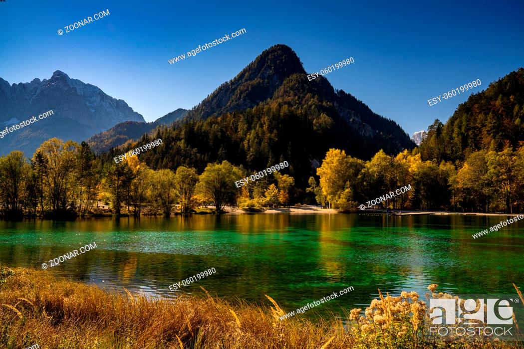 Stock Photo: A view of Lake Jasna with forest and mountain landscape in beautiful autumn colors.