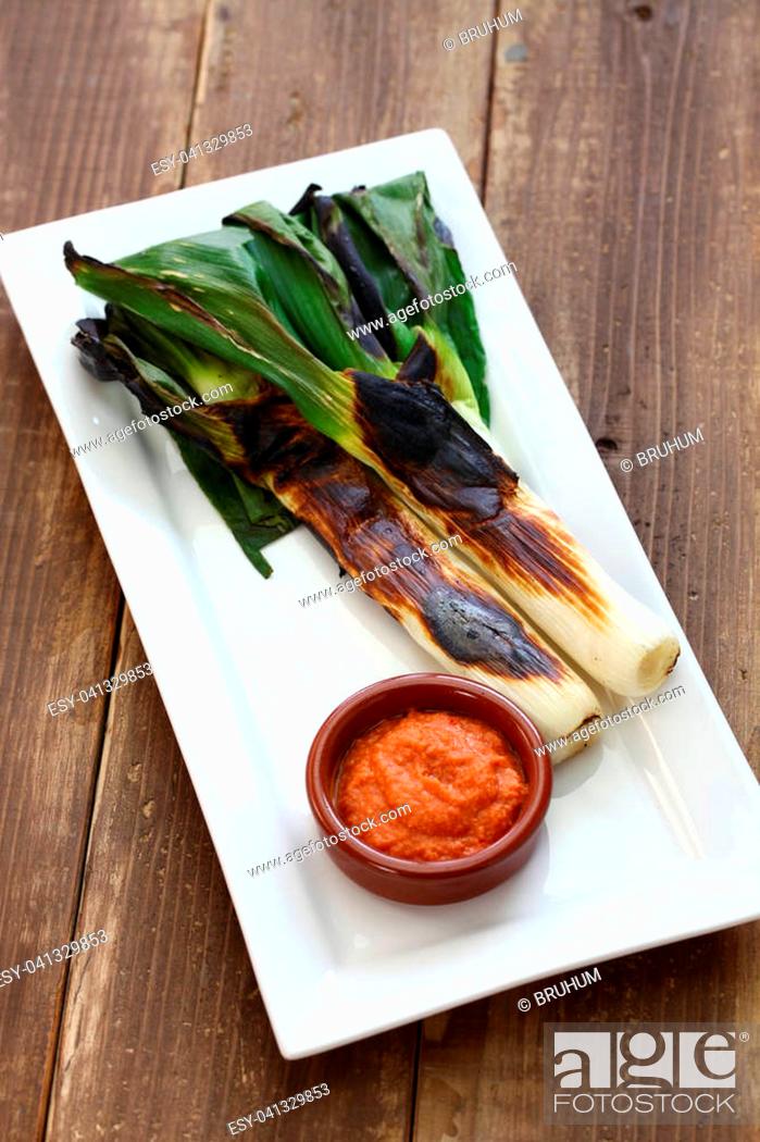 Stock Photo: roasted calcots with romesco sauce for dipping, catalan cuisine.