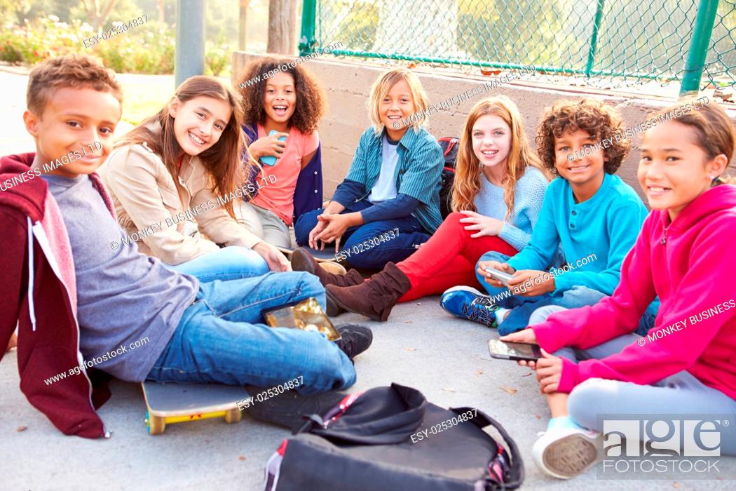 Stock Photo: Group Of Young Children Hanging Out In Playground.
