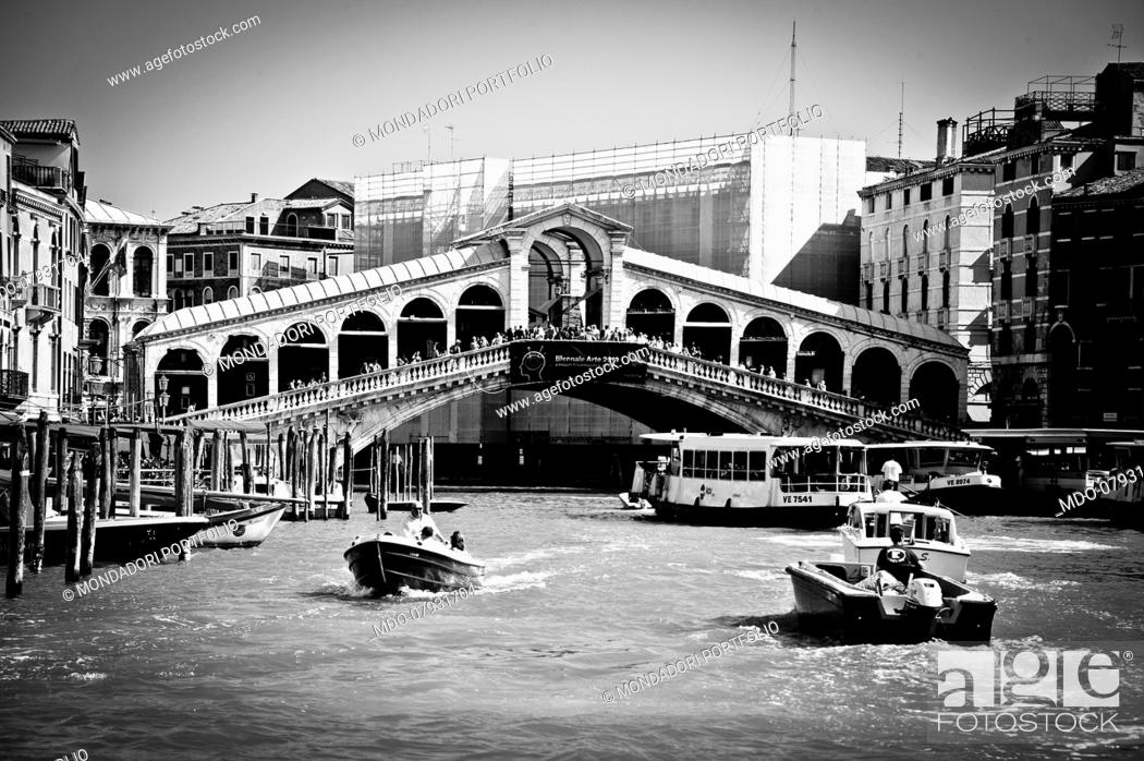 Stock Photo: The typical boats of Venice, the gondolas in Rialto bridge. Venice (italy), September 11th, 2016.