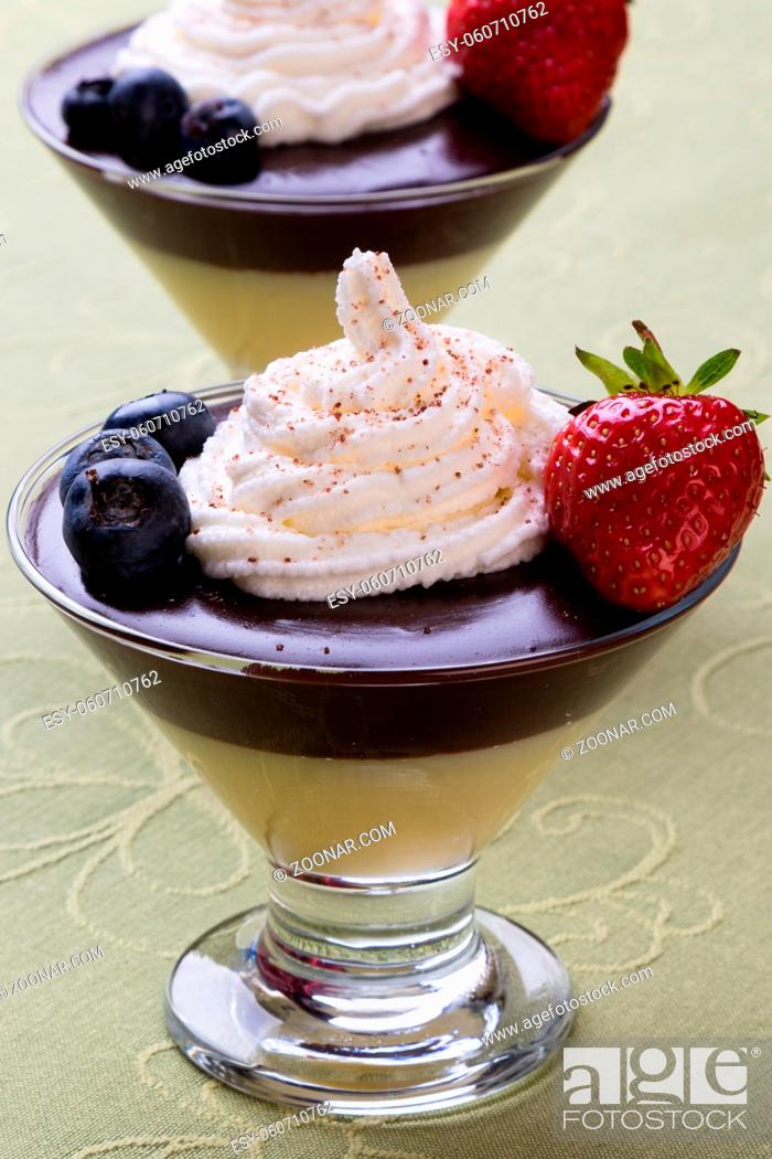 Stock Photo: pudding in glass with whipped cream and fruits.