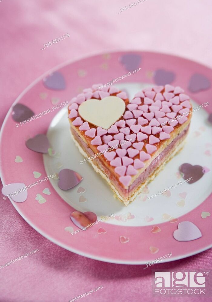Stock Photo: Heartshaped pink cake on plate.