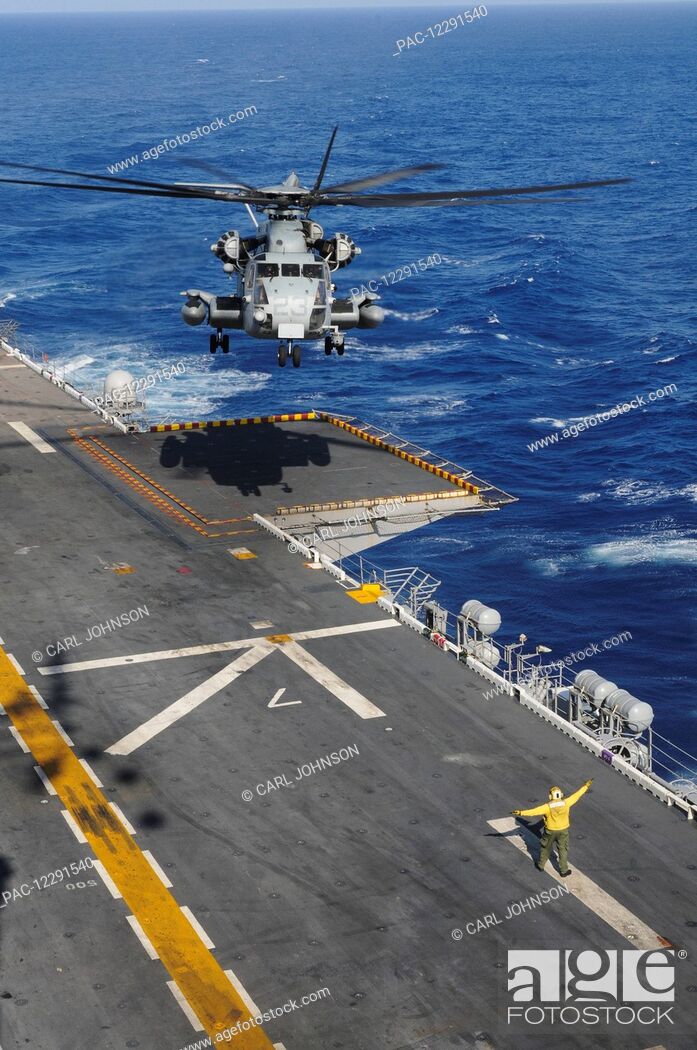 Stock Photo: A CH-53 Sea Stallion helicopter comes in for a landing on the flight deck of the USS Peleliu (LHA-5) out in the Pacific Ocean; Hawaii, United States of America.