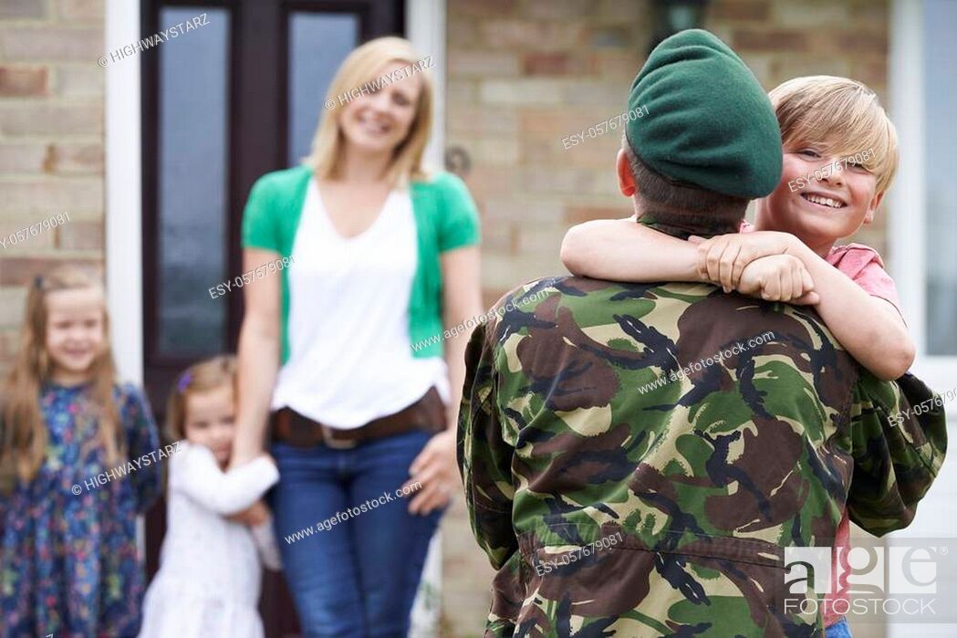Stock Photo: Son Greeting Military Father On Leave At Home.