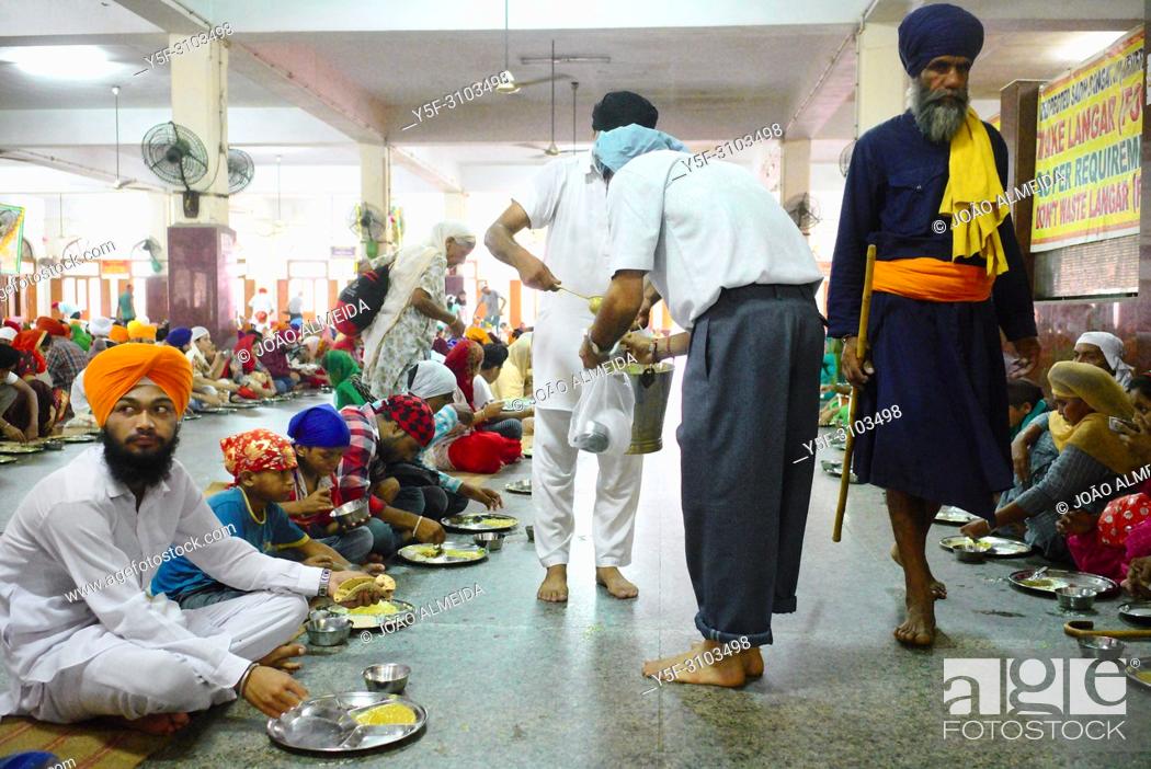 Stock Photo: The langar at Golden temple at Amritsar, where 60000 free meals are served everyday, and that mostly relies on volunteers to run it.