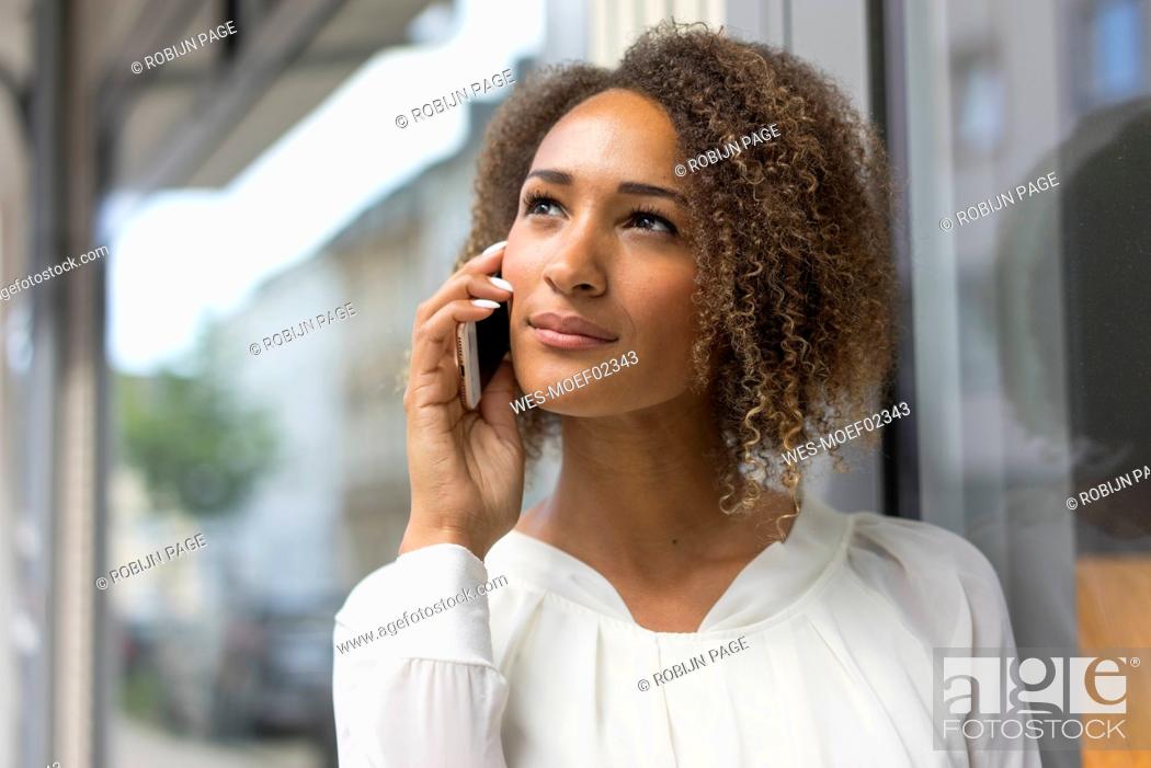 Stock Photo: Portrait of young woman on the phone.
