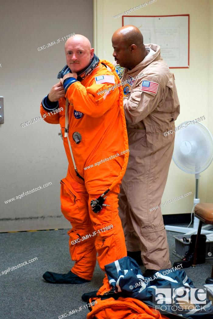 Stock Photo: NASA astronaut Mark Kelly, STS-134 commander, dons a training version of his shuttle launch and entry suit in preparation for a training session in the.