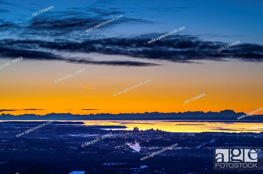 Stock Photo: Anchorage, Alaska as seen from Arctic Valley Road while the sun sets on a winters night. The Cook Inlet and the Alaska Range are in the background; Anchorage.