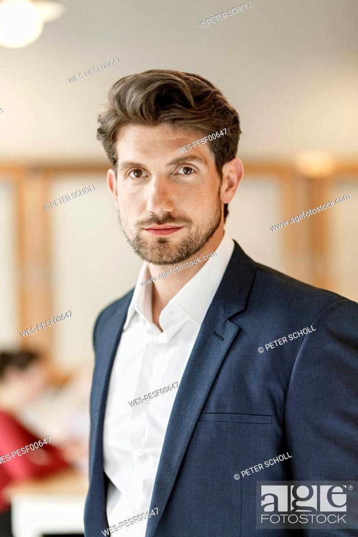 Stock Photo: Portrait of serious businessman in office.