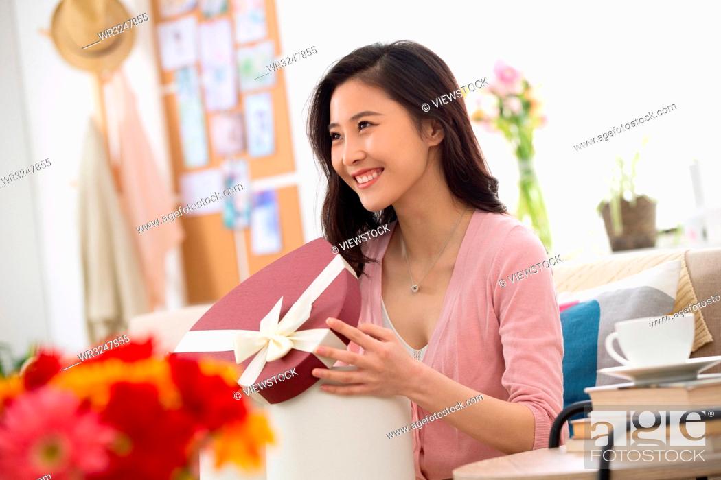 Stock Photo: Young women receive gifts.