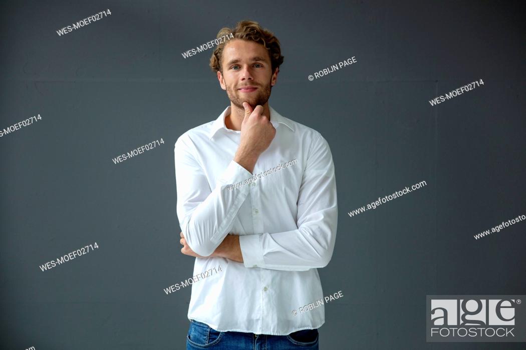 Stock Photo: Portrait of young businessman, wearing white shirt.