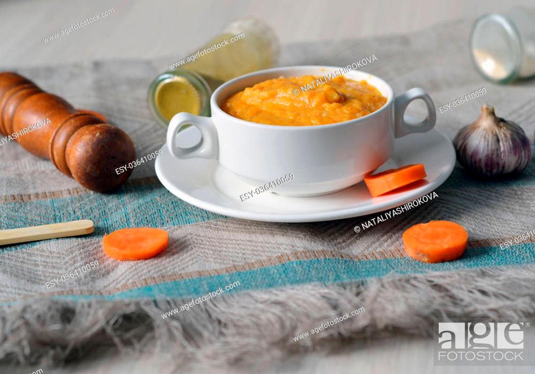 Stock Photo: Tasty hot vegetable carrot soup in a bowl.