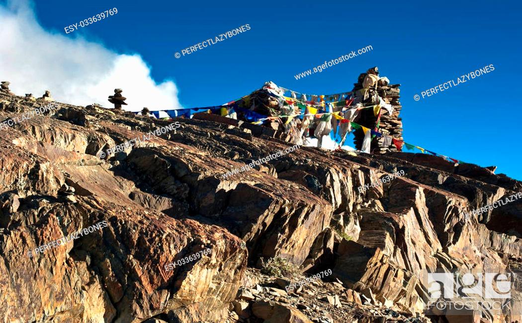 Stock Photo: Buddhist stone tower with praying flags at Himalaya mountain road pass at Manali - Leh highway over blue sky. India, Ladakh, altitude 4500m.