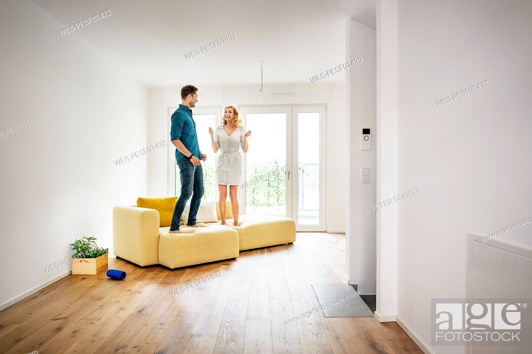 Couple Jumping For Joy On Couch In, Joy Floors Hardwood Floor Services