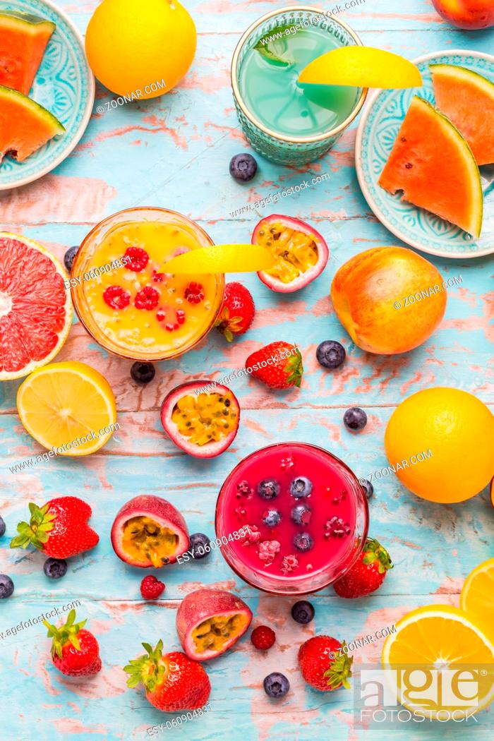 Stock Photo: Variation of smoothies and refreshing drinks with fresh fruits for hot summer on blue background.