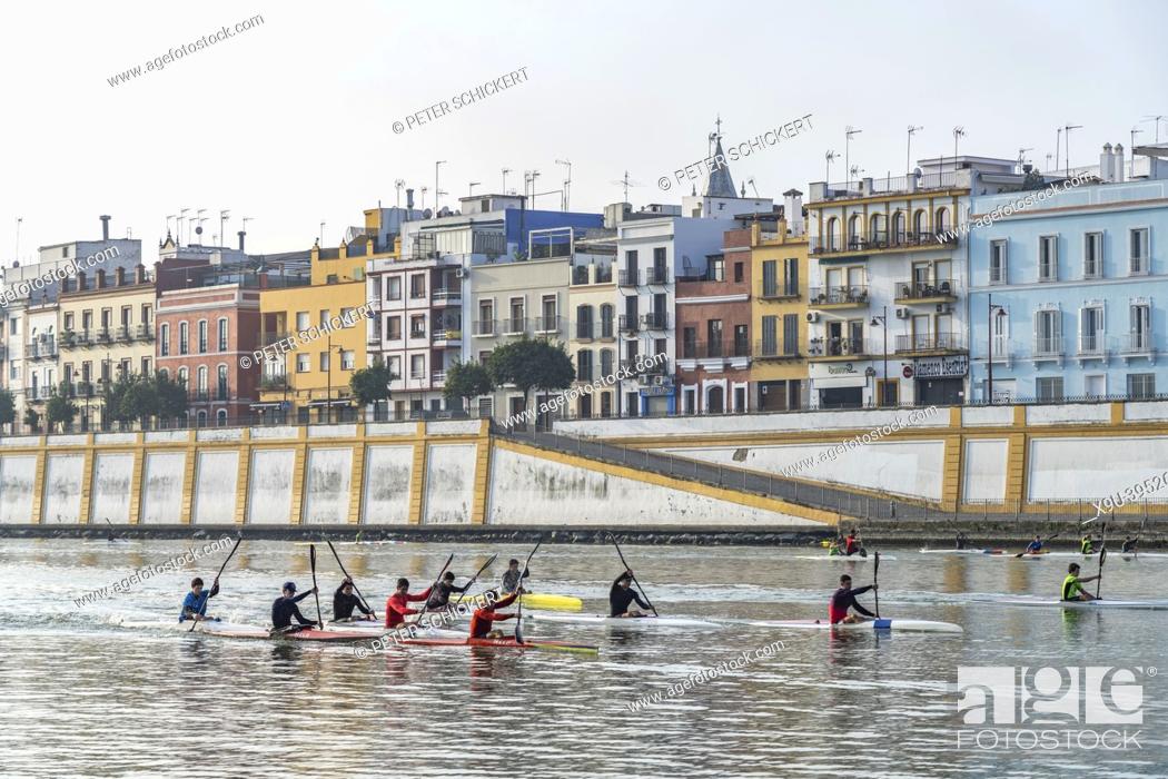 Stock Photo: Kayaks on the Guadalquivir river and the Triana quarter, Seville, Andalusia, Spain.