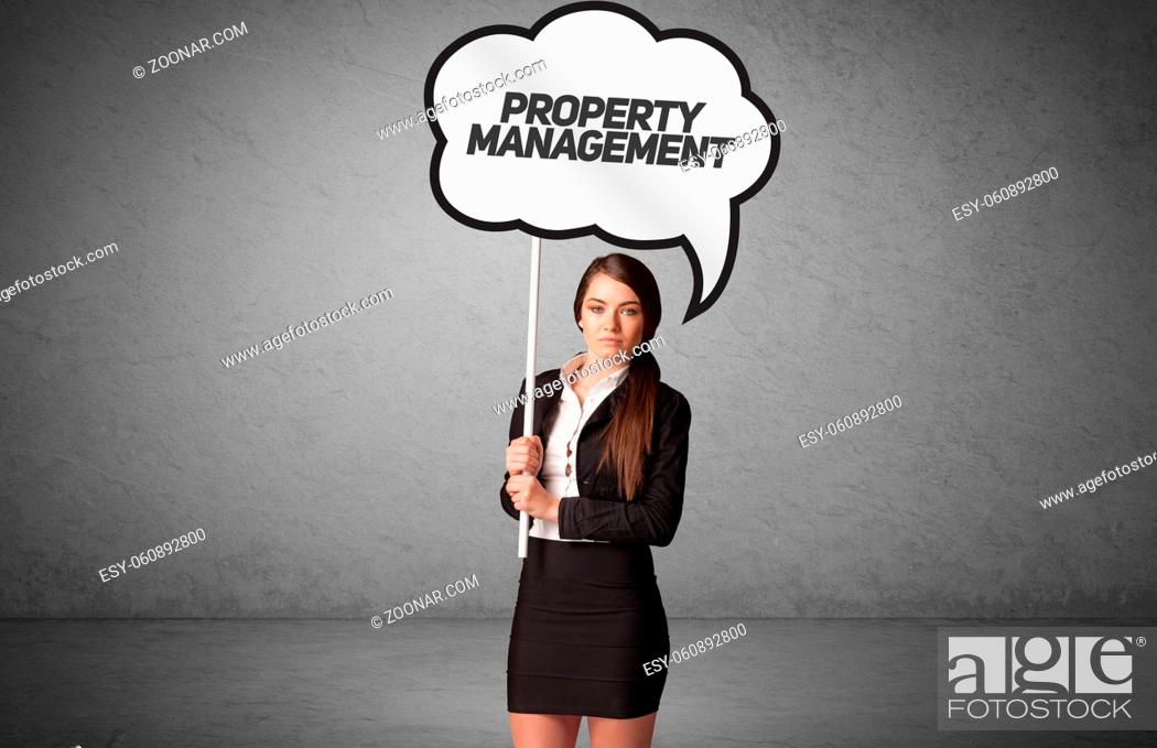 Stock Photo: Young business person in casual holding road sign with PROPERTY MANAGEMENT inscription, new business idea concept.