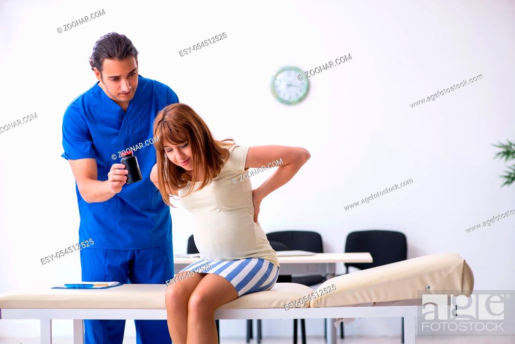 Stock Photo: The pregnant woman visiting male doctor gynecologist.