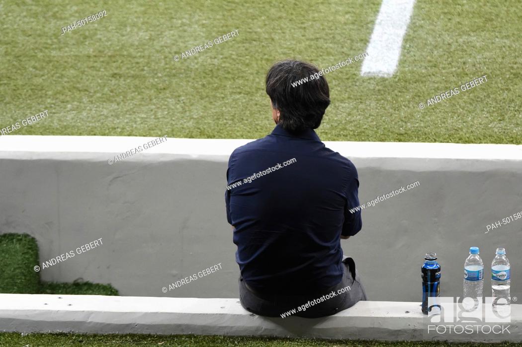 Stock Photo: German head coach Joachim Loew sits on a wall during the FIFA World Cup 2014 semi-final soccer match between Brazil and Germany at Estadio Mineirao in Belo.